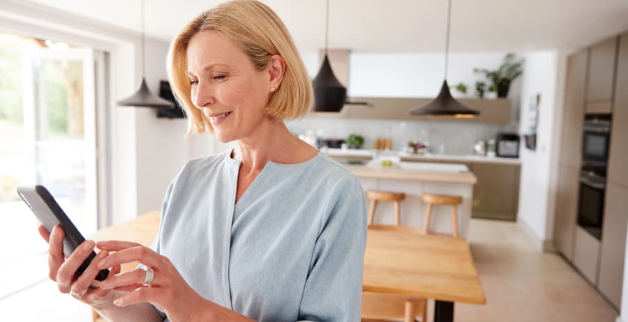 Resident using a cell phone in a stylish home